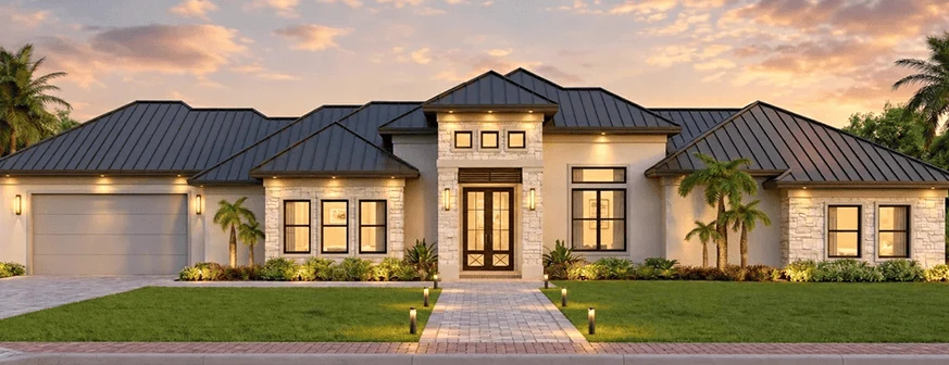 The Ideal Home, a single story home with a metal roof, stone detailing and a two car garage